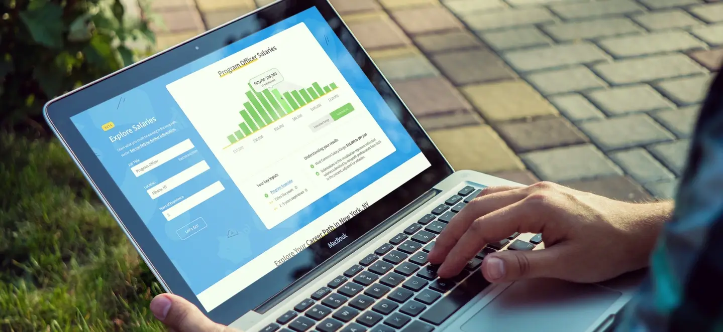 Idealist's Nonprofit Salary Explorer on a laptop screen.